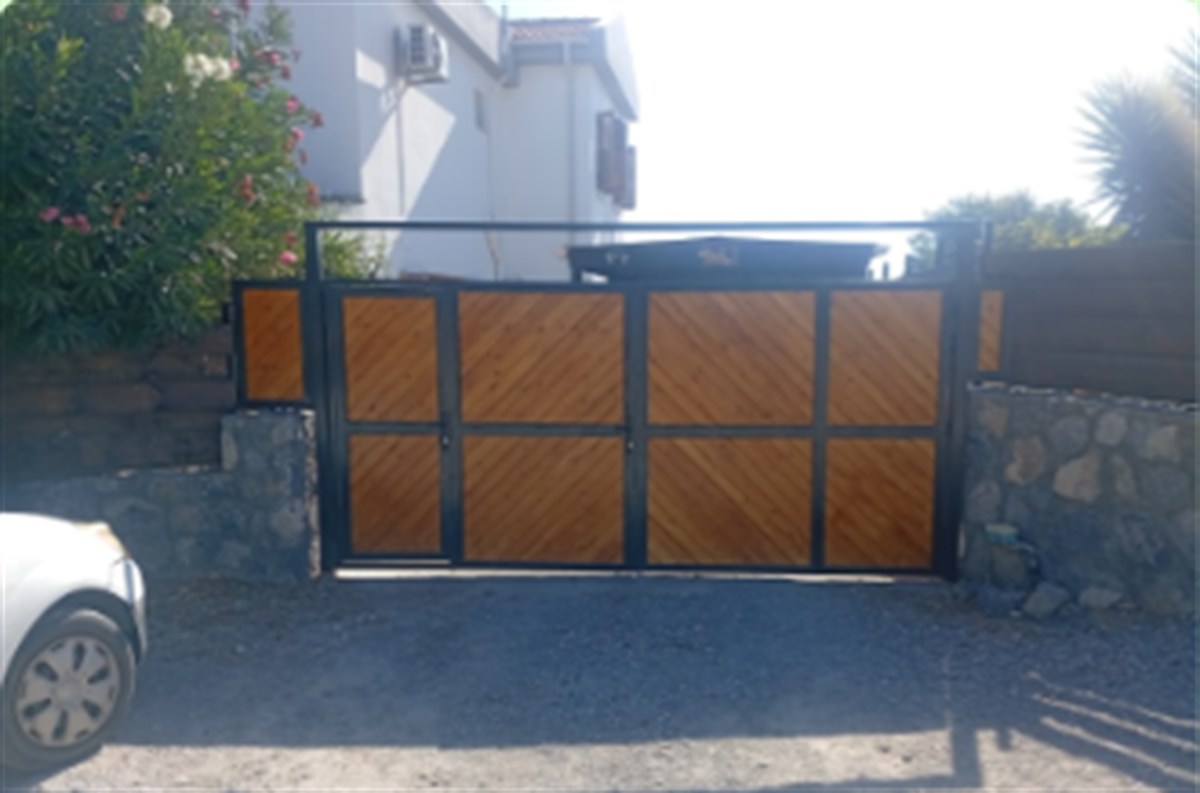 Finished custom steel and timber driveway gate after the second coat of stain